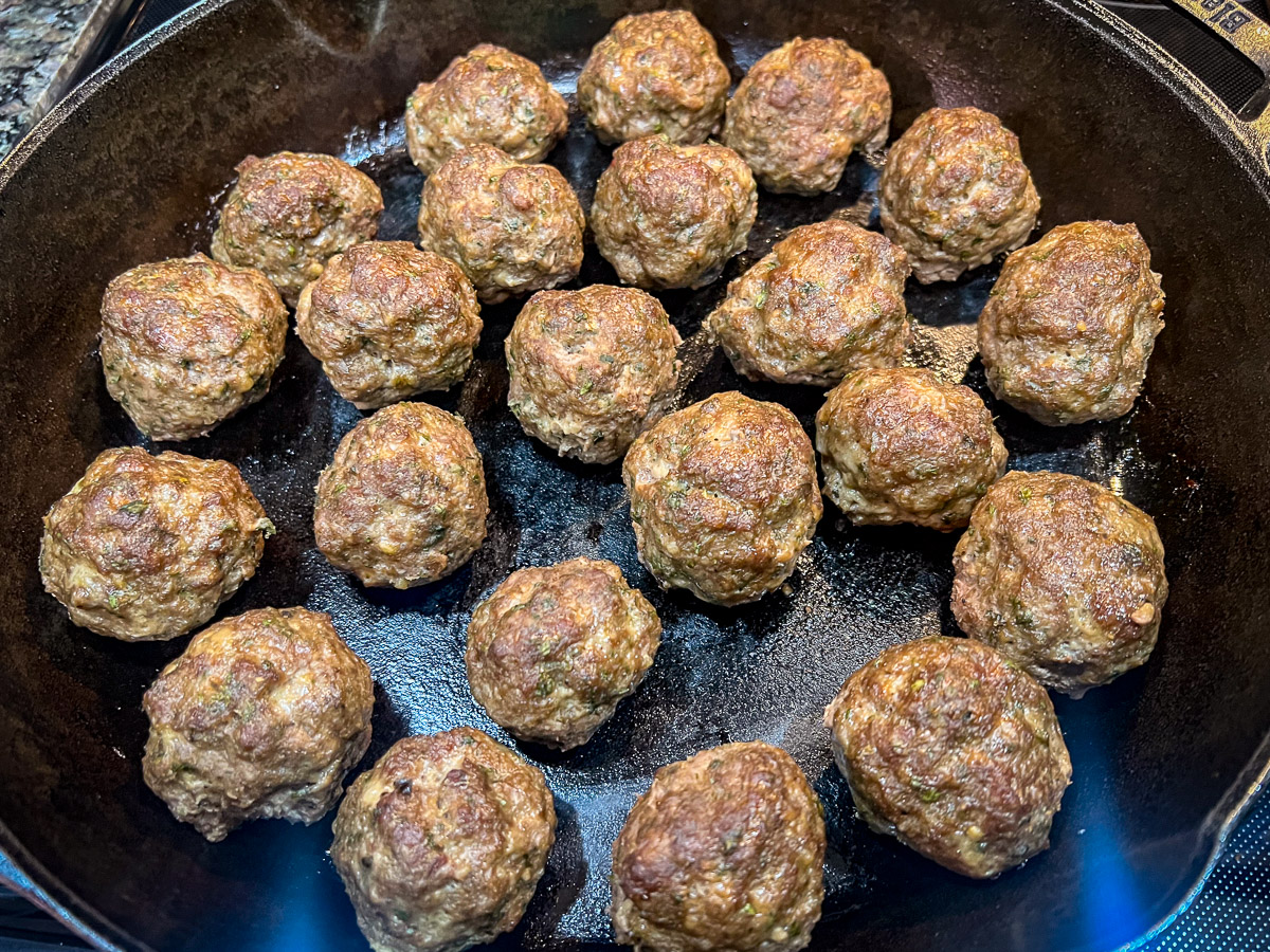 Cooked skillet meatballs after removing pan from the oven.