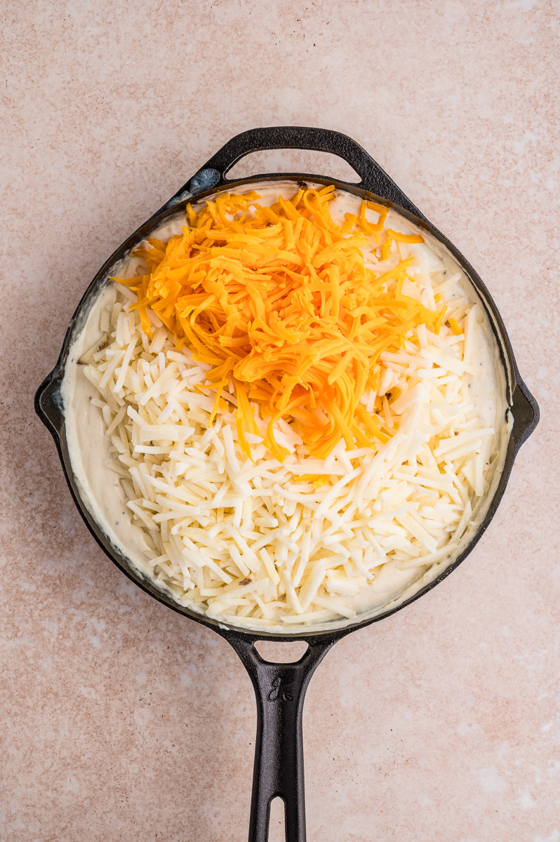 Cheese and hash browns added to the dish.