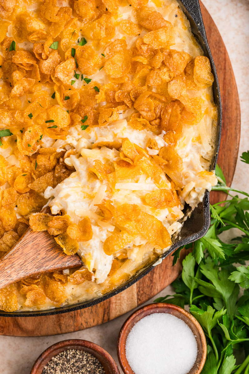 A dish of smoked funeral potatoes on a table.