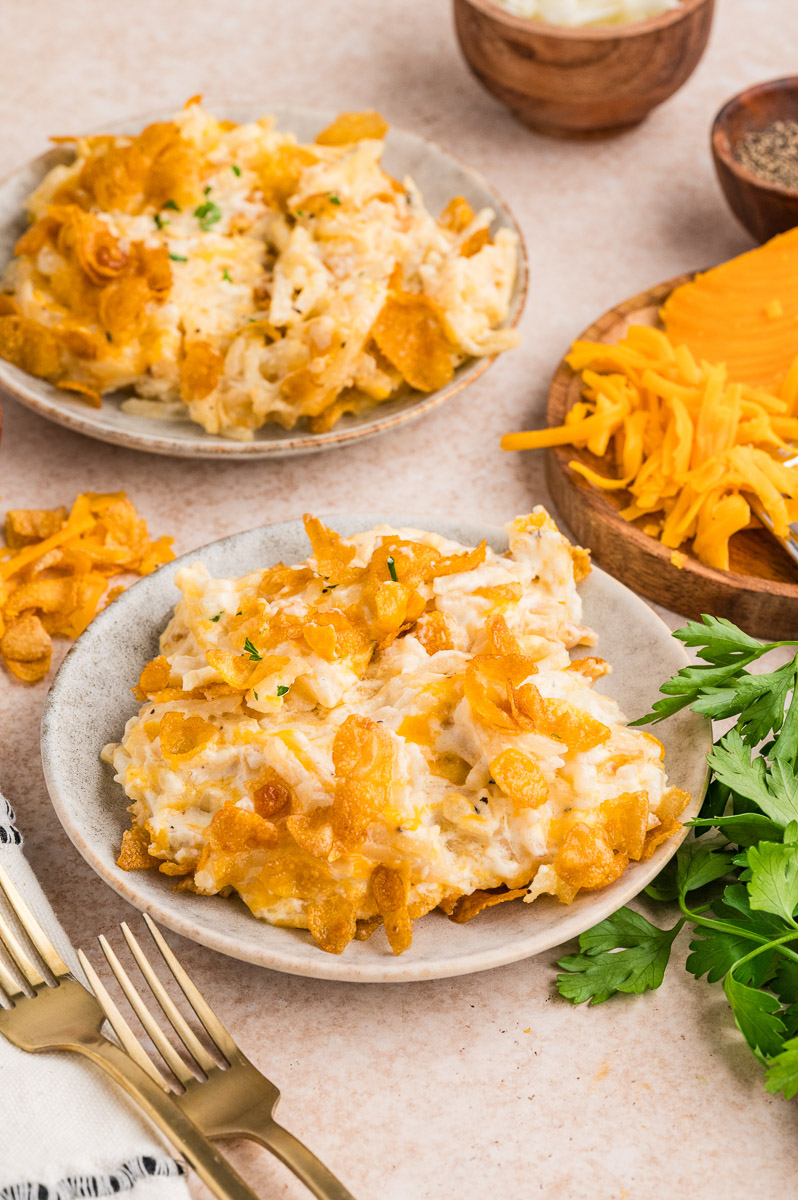 Dutch oven funeral potatoes served on plates on a table.