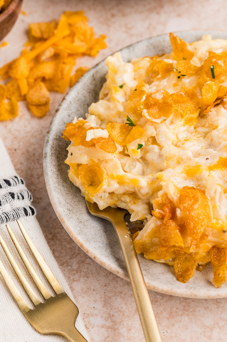 A plate of smoked funeral potatoes on the table.