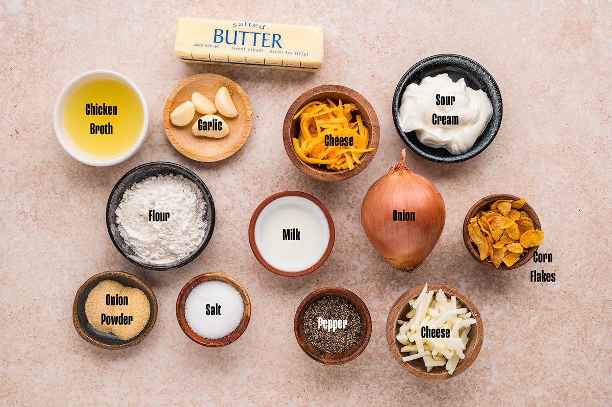 Ingredients to make cheesy potatoes in bowls on a table.