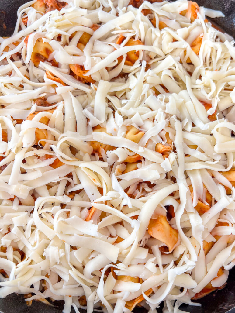 Remaining reserved mozzarella cheese sprinkled over the entire pasta in the skillet.