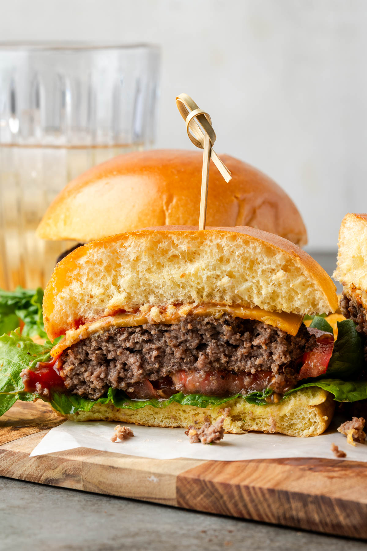 A half of bison burger on a cutting board.