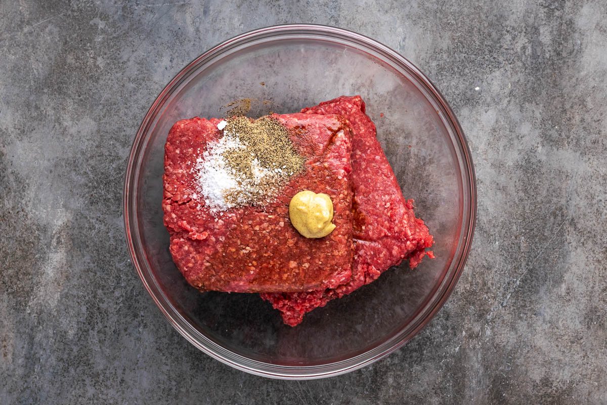 Ground bison, seasonings, Worcestershire sauce, Dijon, and water to a bowl.