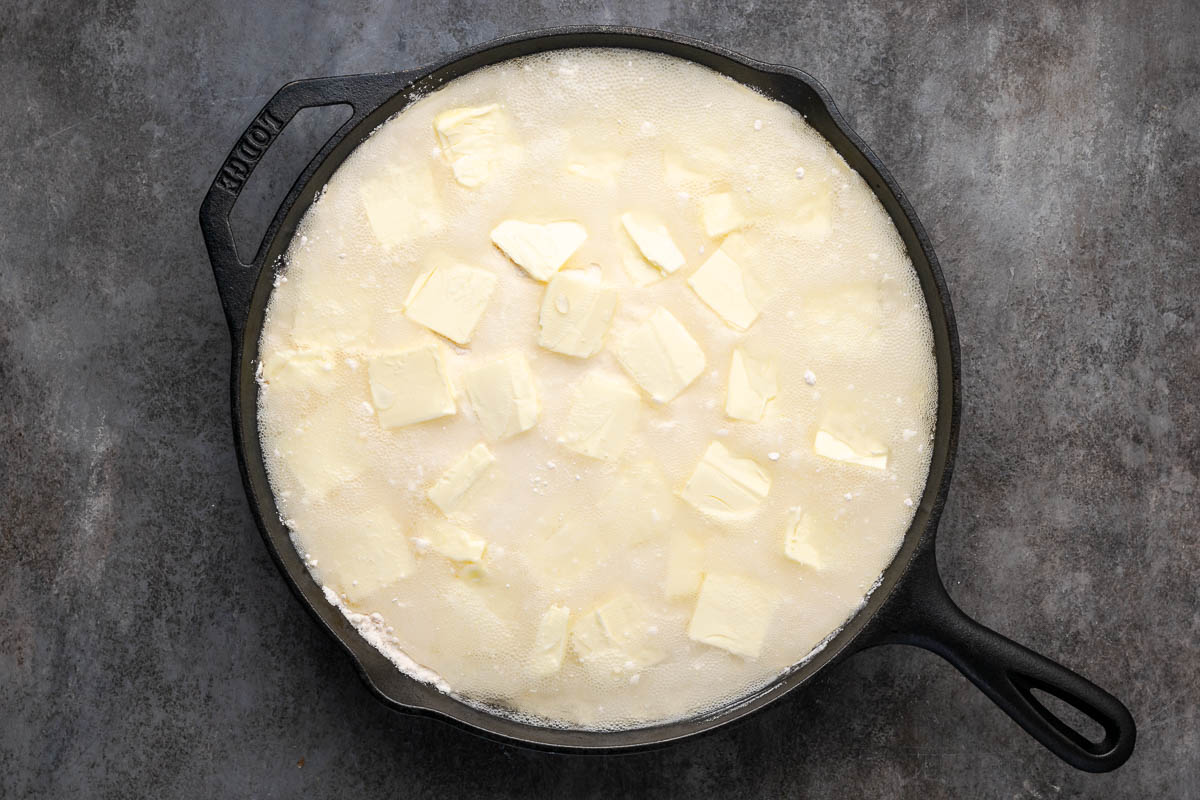 Soda poured on top of the lemon blueberry dump cake before baking.