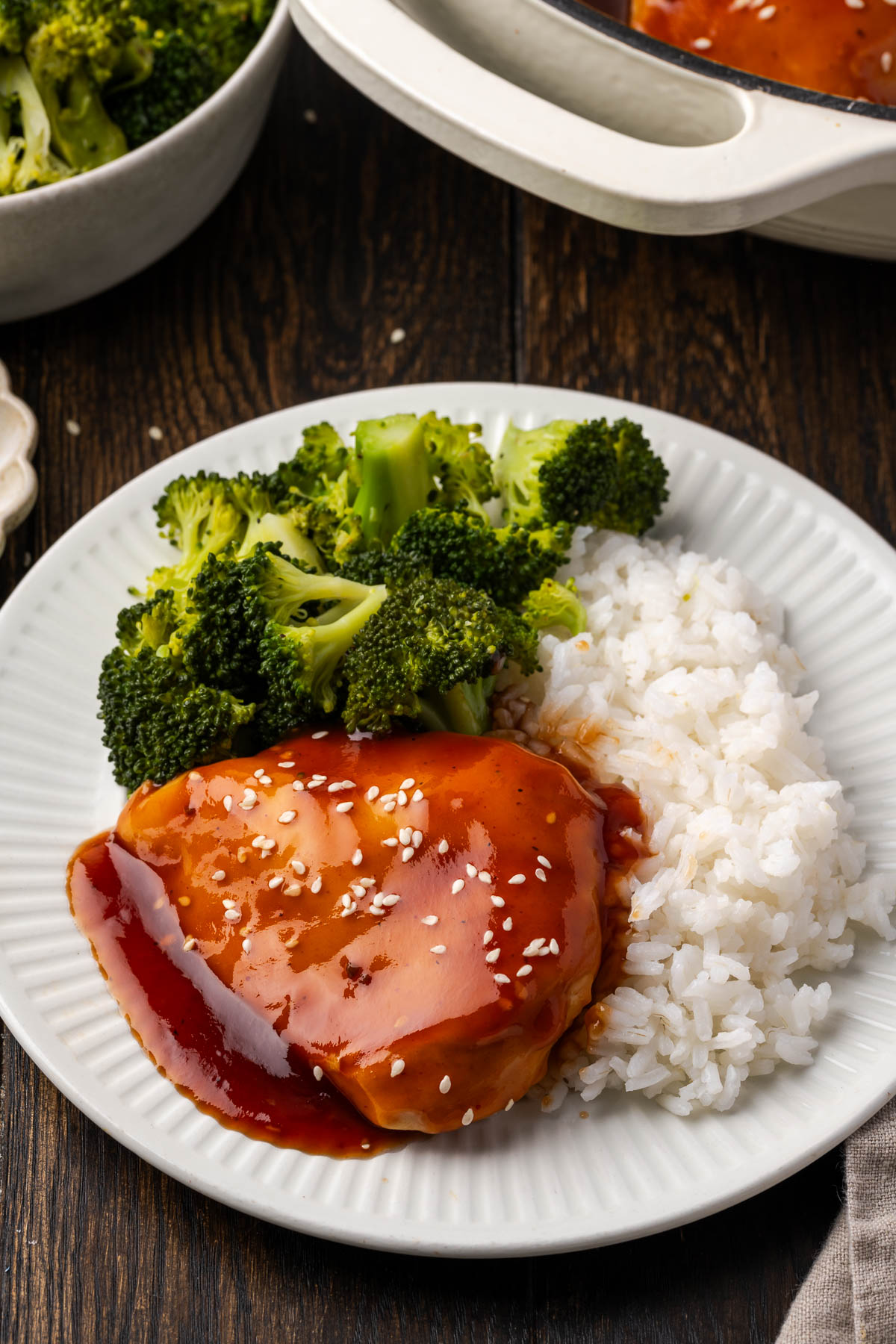 Teriyaki BBQ chicken on a plate with broccoli and rice.