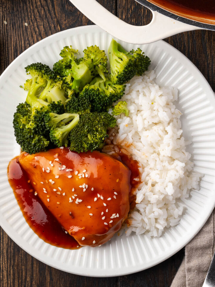 A plate of teriyaki BBQ chicken, rice and broccoli.