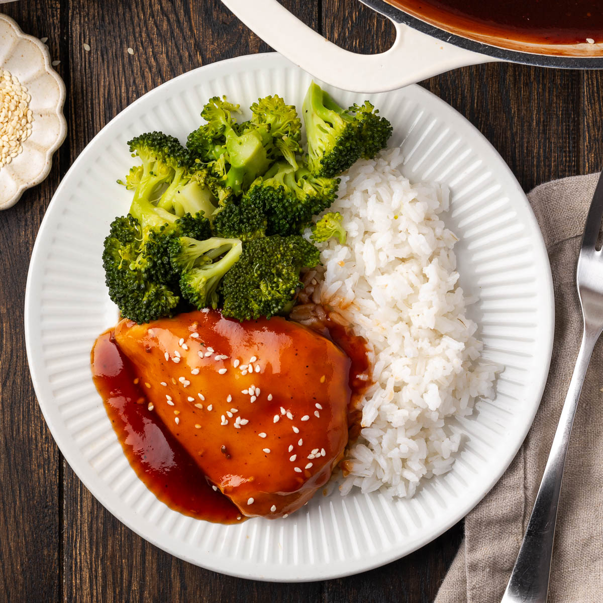 A plate of teriyaki BBQ chicken, rice and broccoli.
