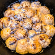 Dutch oven cinnamon rolls with icing on top.