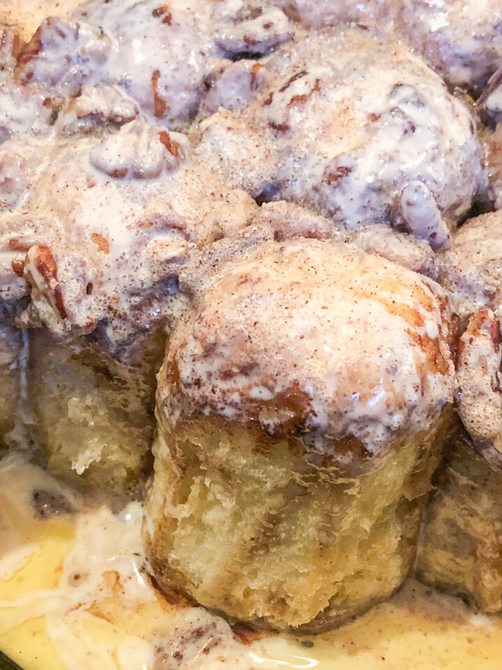 Dutch oven cinnamon rolls with a few pulled from the dish.