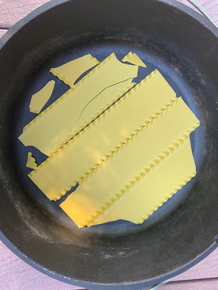Broken lasagna noodles added to the bottom of the pot.