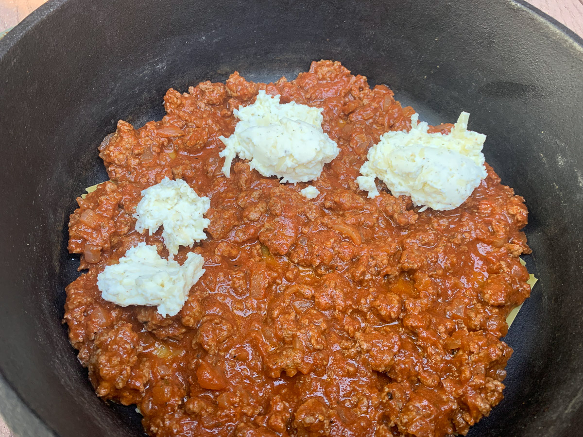 Adding the cheese on top of the meat mixture.