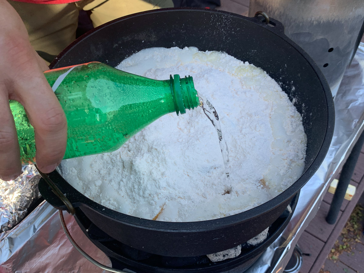 Lemon-lime soda being poured over the cake mix.