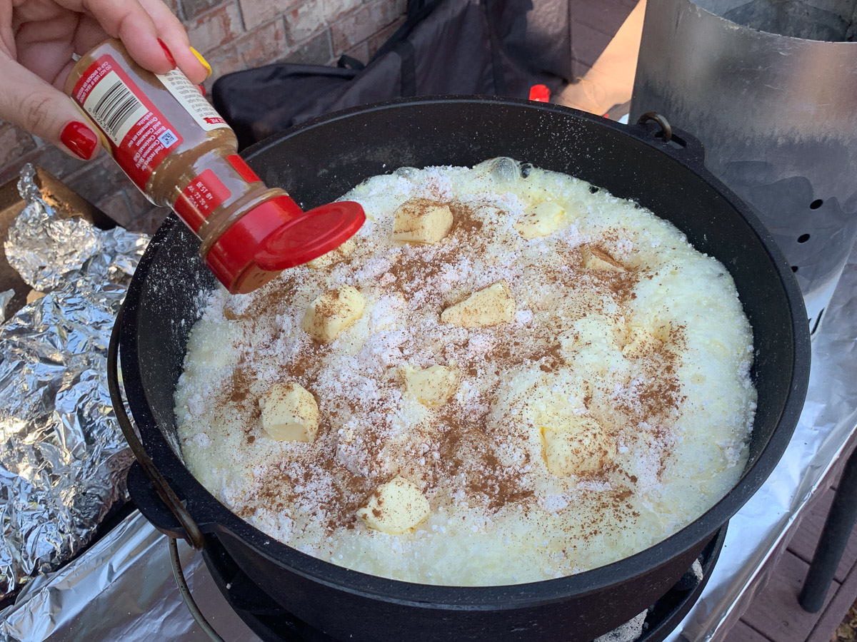 Cinnamon being sprinkled on top of the cake mix.