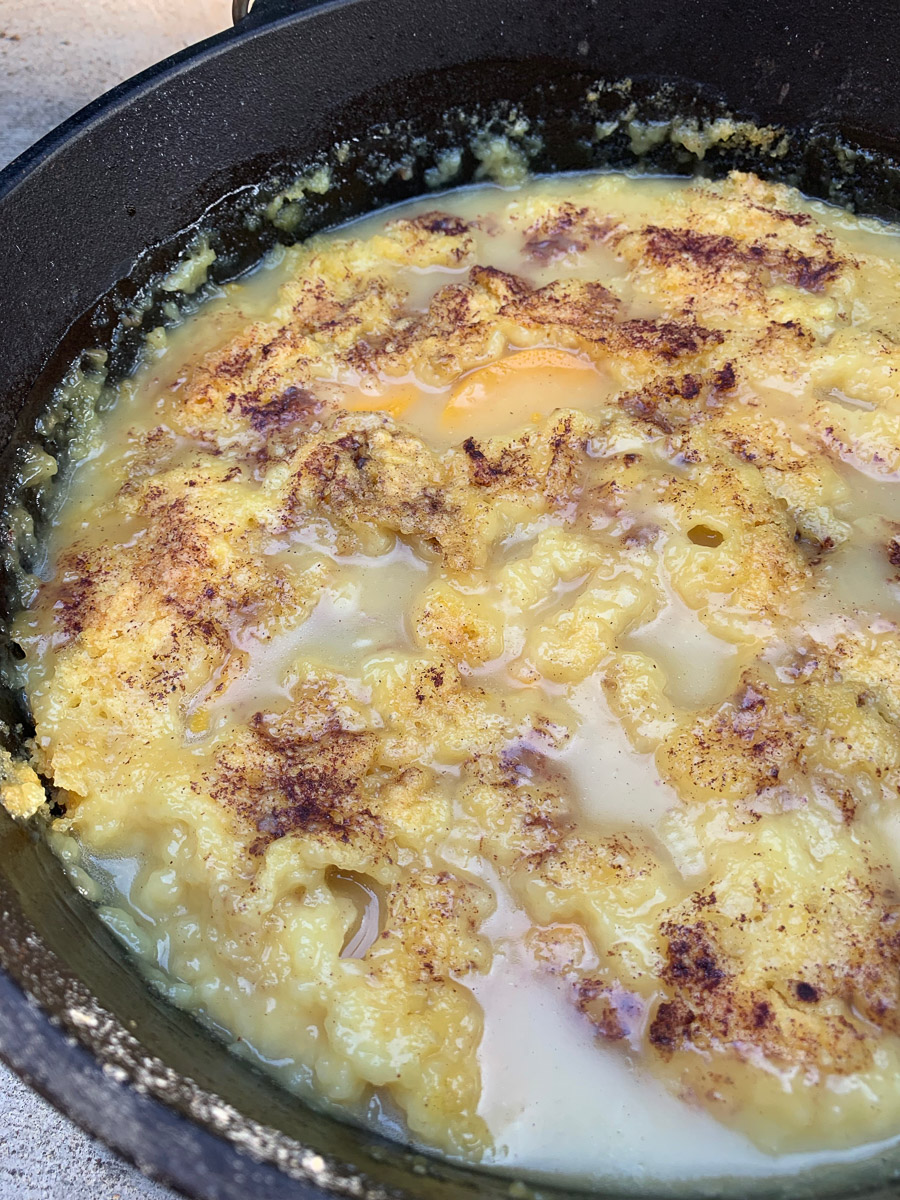 A cast iron filled with peach dump cake.