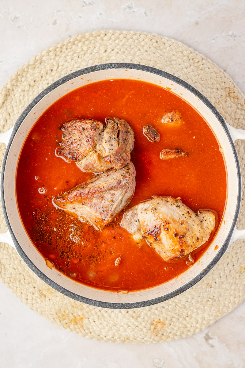 Pork added to the sauce to cook.