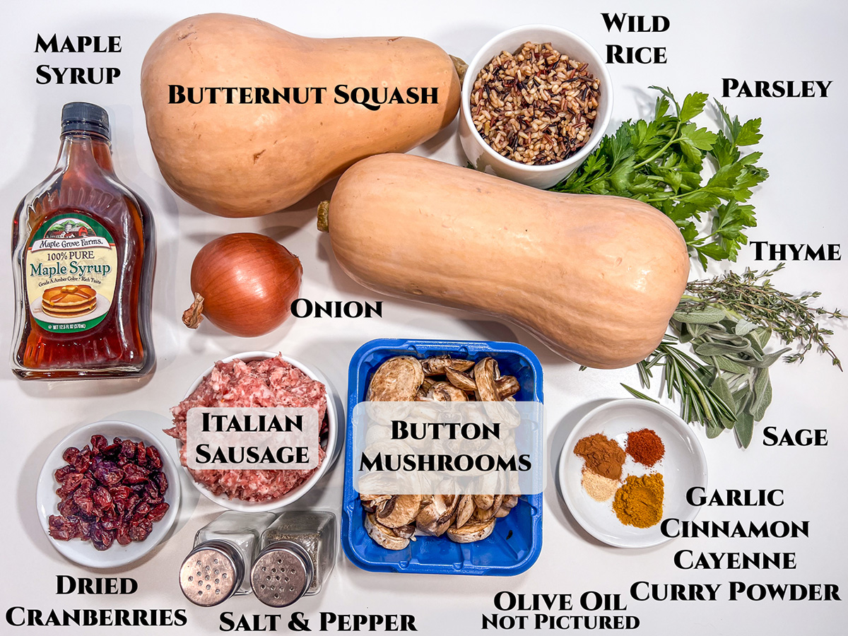 Ingredients to make Sausage Stuffed Butternut Squash: butternut squash, wild rice, parsley, thyme, sage, garlic, cinnamon, cayenne, curry powder, olive oil, mushrooms, salt, pepper, Italian sausage, dried cranberries, onion, and maple syrup.