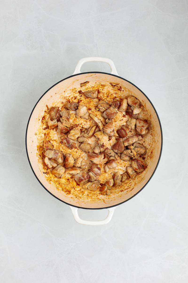Chicken cooking in a pan.