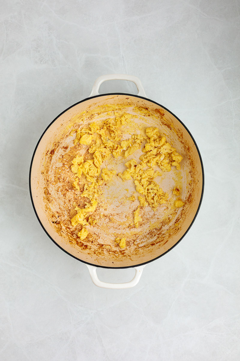 Eggs scrambled in a pan.