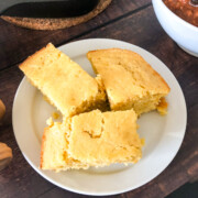 Slices of creamed corn cornbread on a white plate.