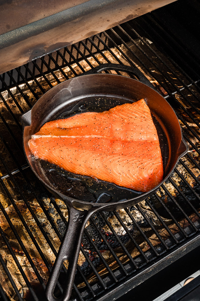 Salmon on a cast iron skillet to cook.