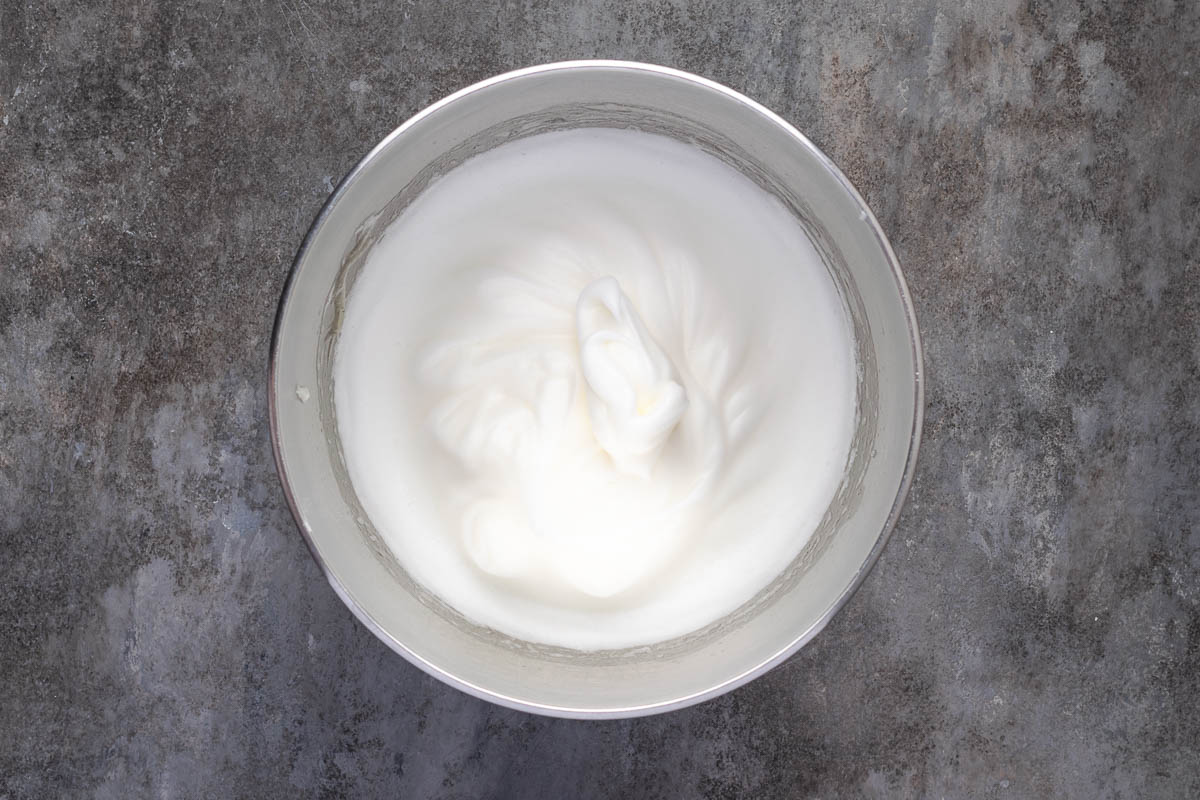 Egg whites and cream of tartar beaten in another bowl.