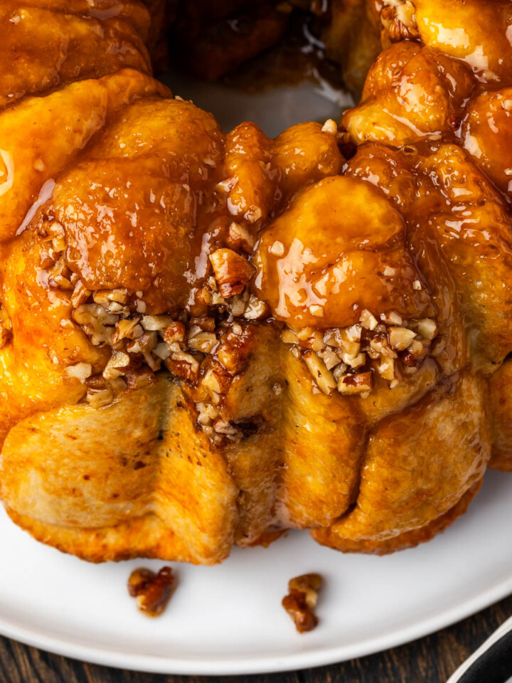 Monkey bread with buttterscotch pudding on a plate with nuts.