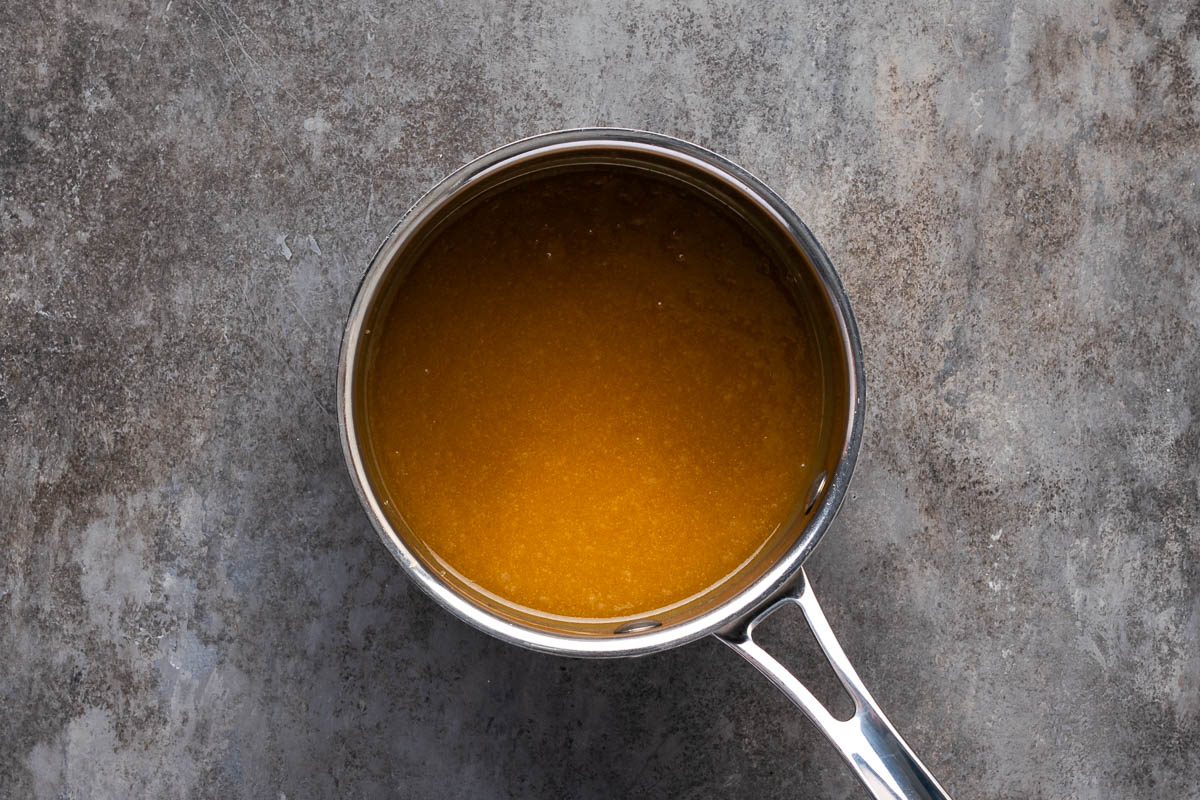 Sauce for butterscotch monkey bread in a saucepan.