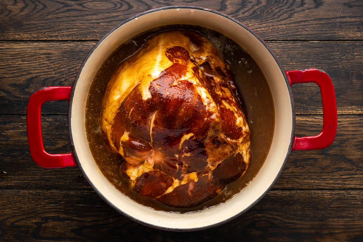 The ham glaze poured over the ham.