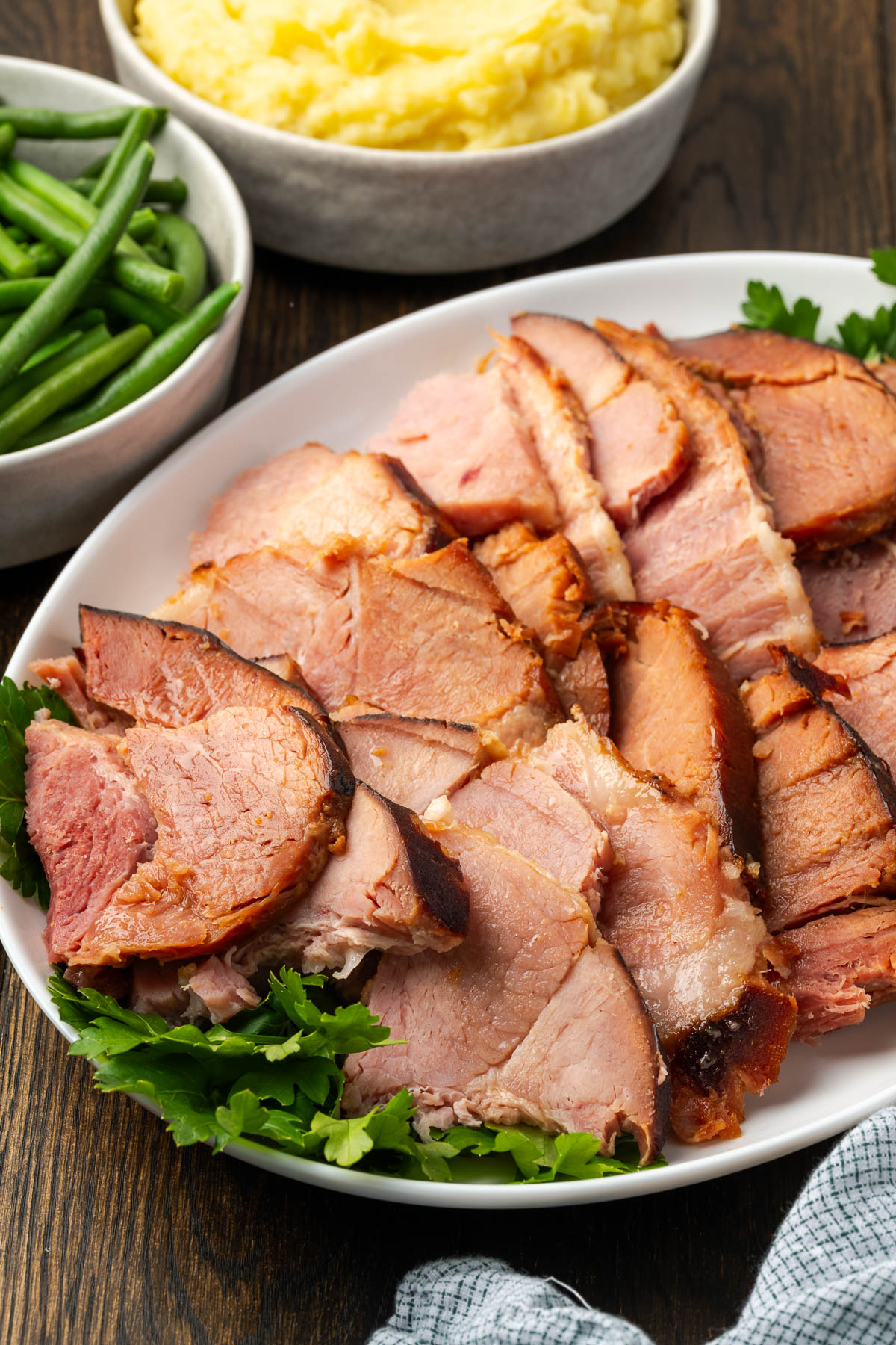 Slices of dutch oven ham on a serving plate.