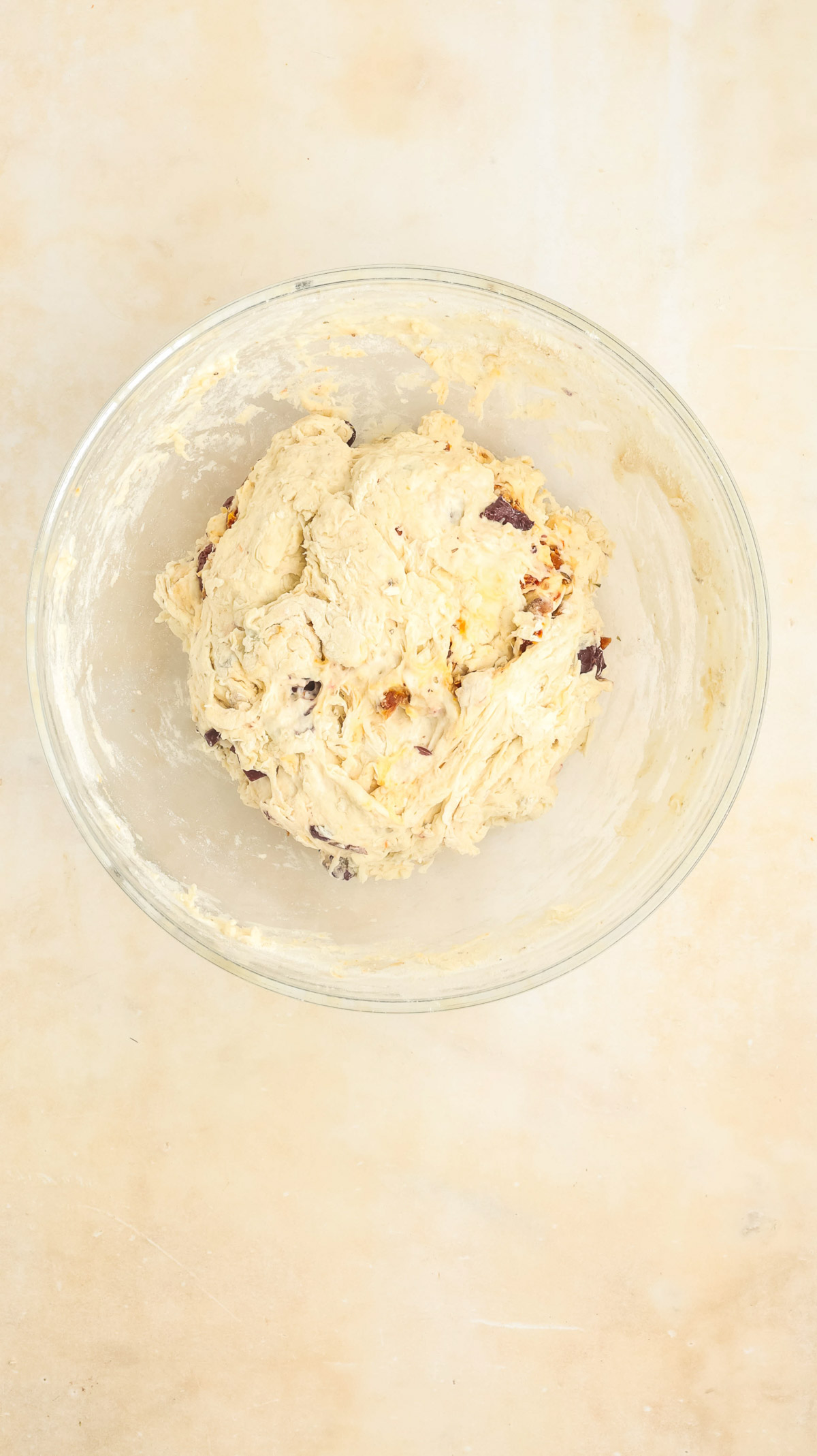 Dough in a clear bowl.