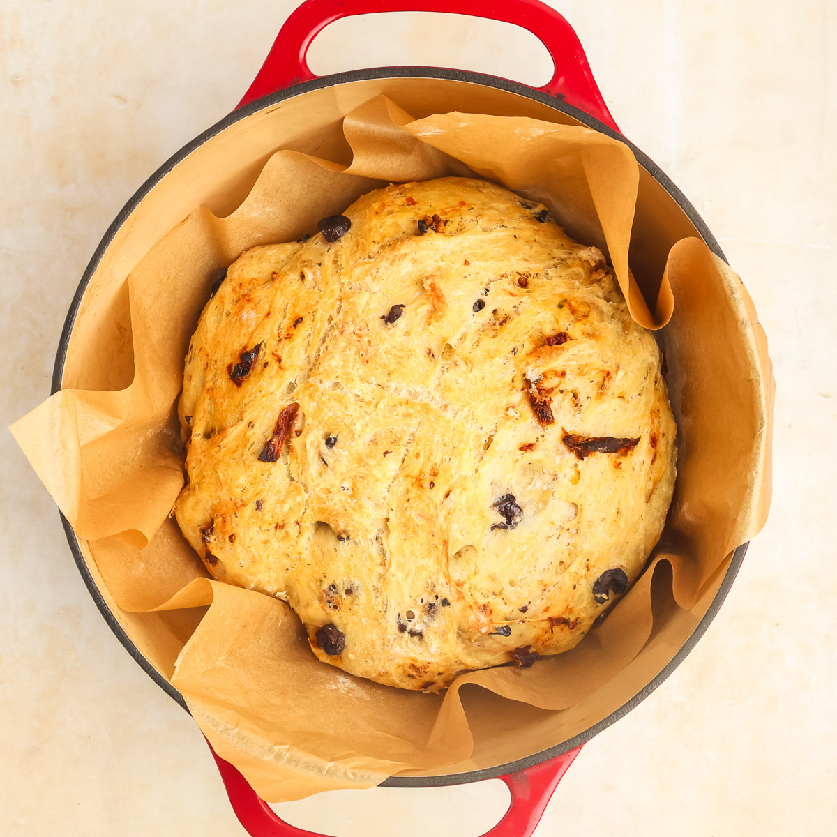 Artesian Italian Bread in a red enameled Dutch Oven.