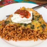 A plated serving of Baked Mexican Spaghetti garnished with cilantro and green onions.