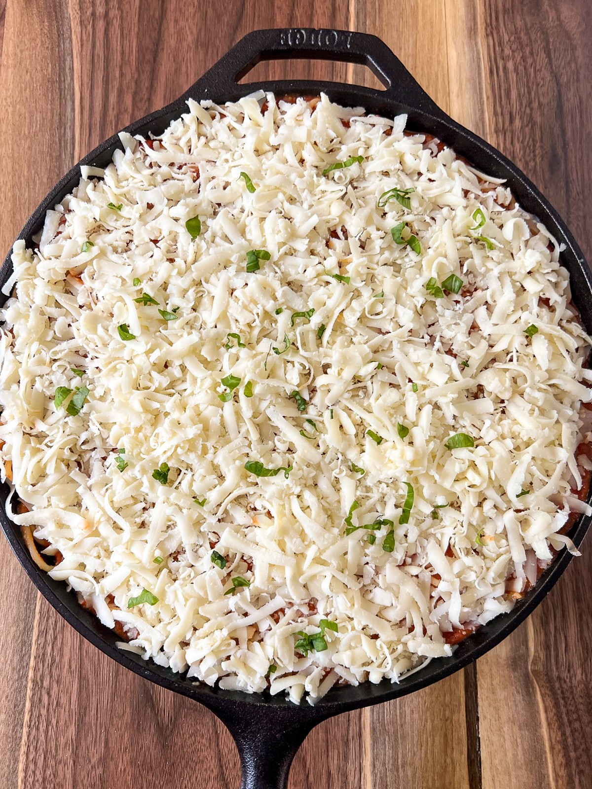Repeated layers of pasta, sauce, and cheese completed and the pasta is ready to bake.
