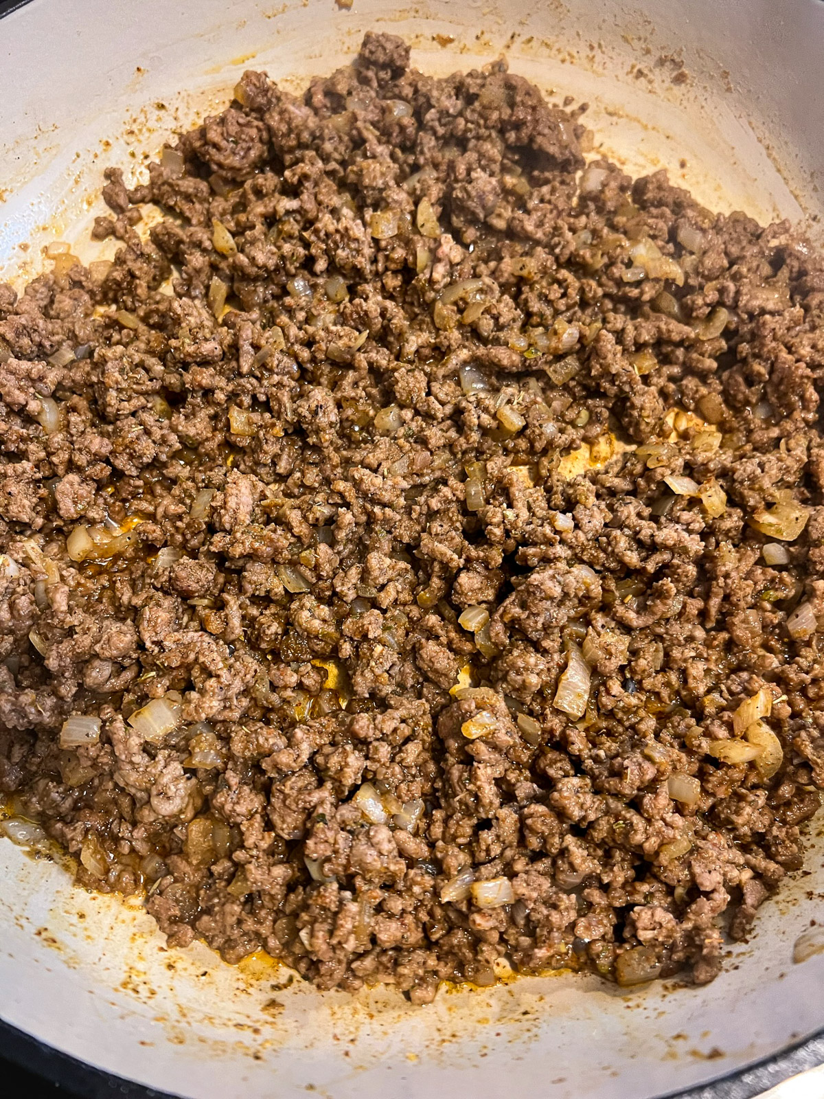 Taco seasoning added to the cooked beef mixture.
