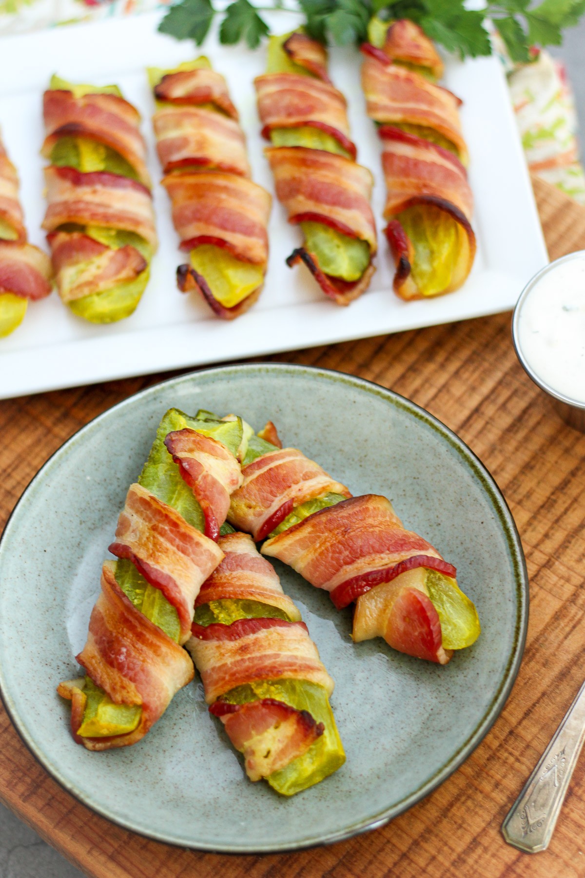 A plate of pickles wrapped in bacon.