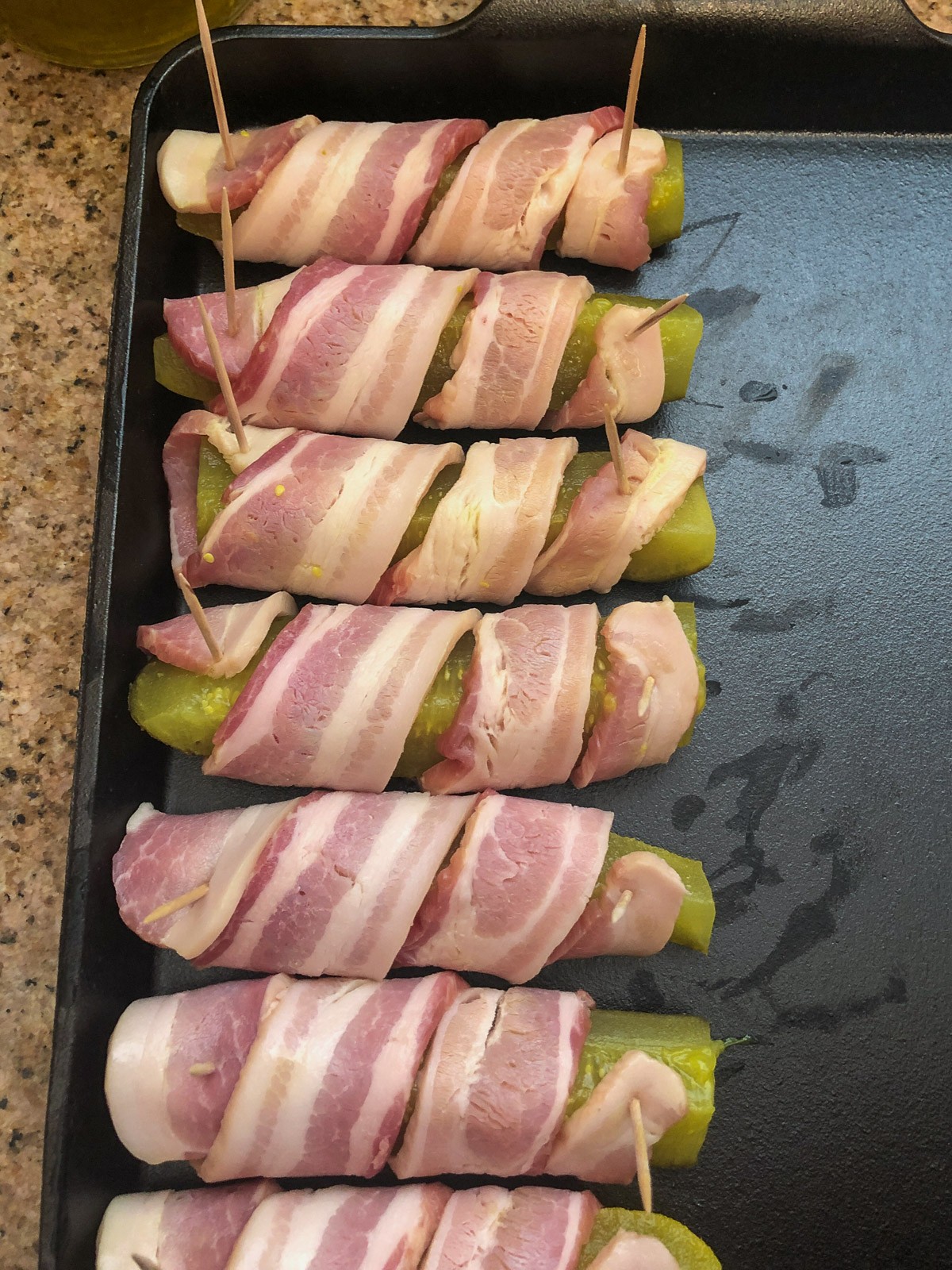 A row of bacon pickles prepped.