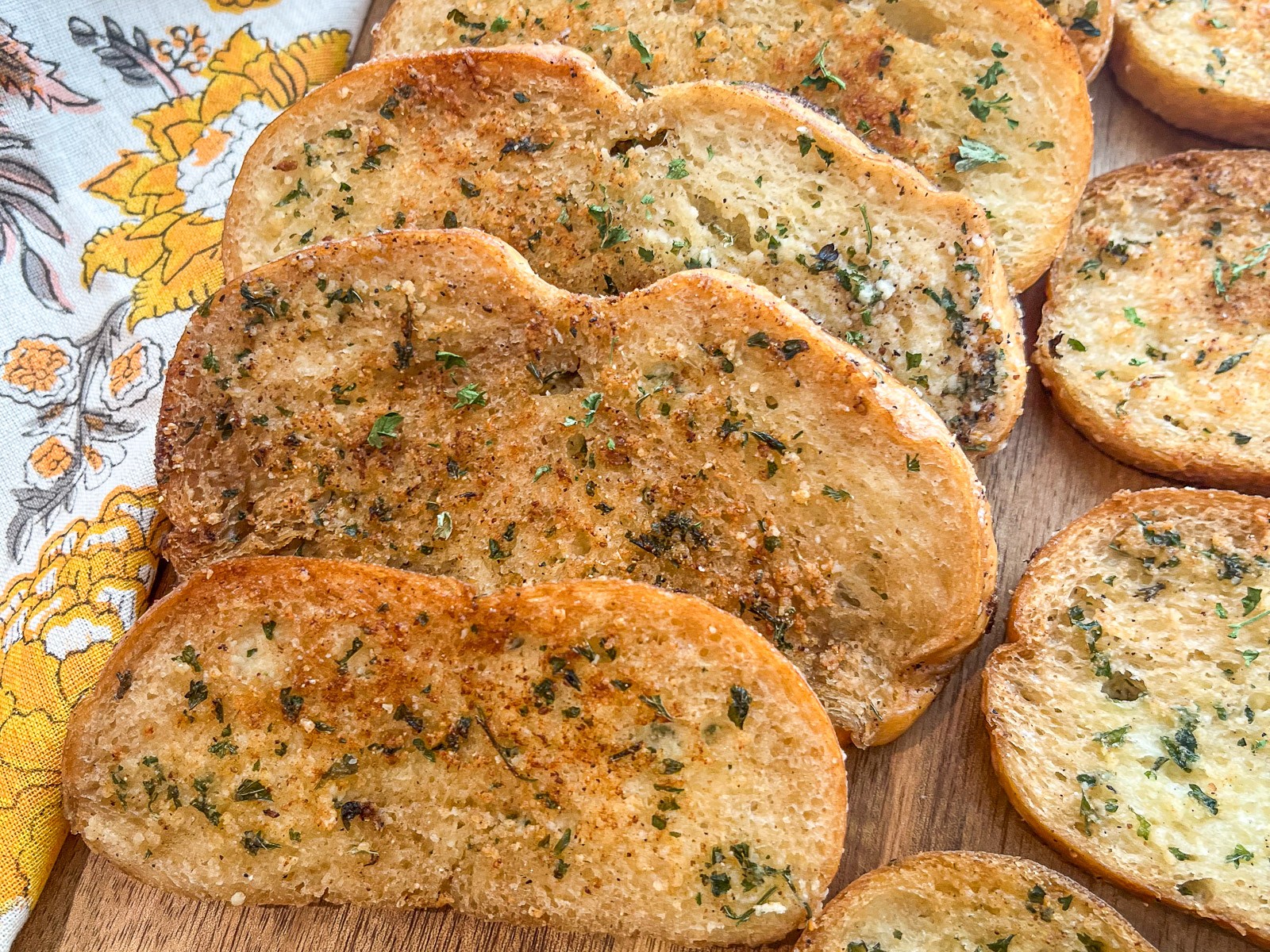 Slices of garlic bread on a cutting board.