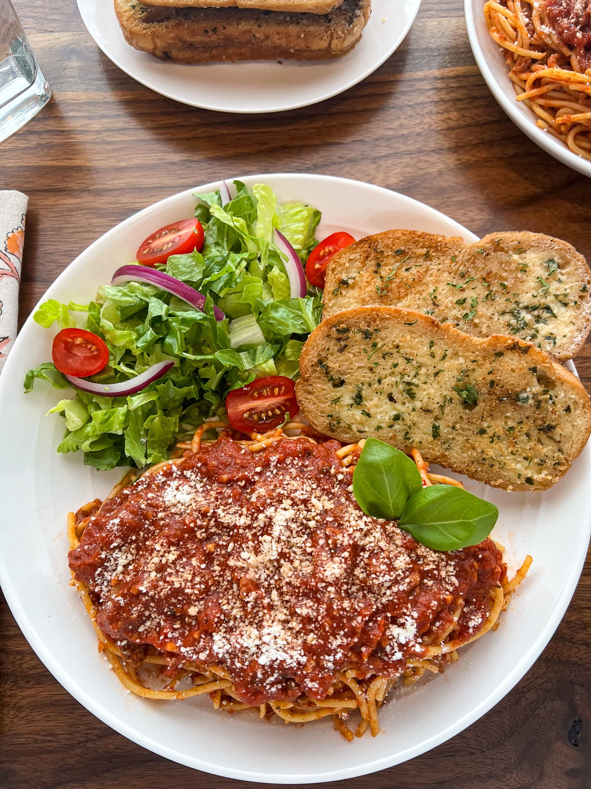 Cast Iron Garlic Bread on a plate with spaghetti.