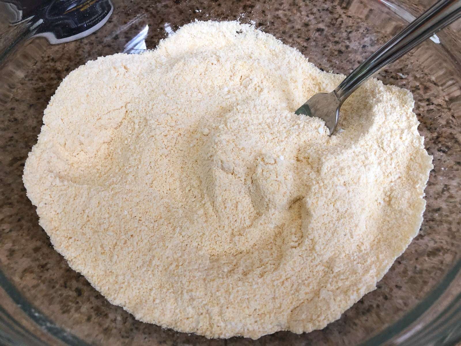 The dry ingredients added to a bowl and mixed together with a fork.