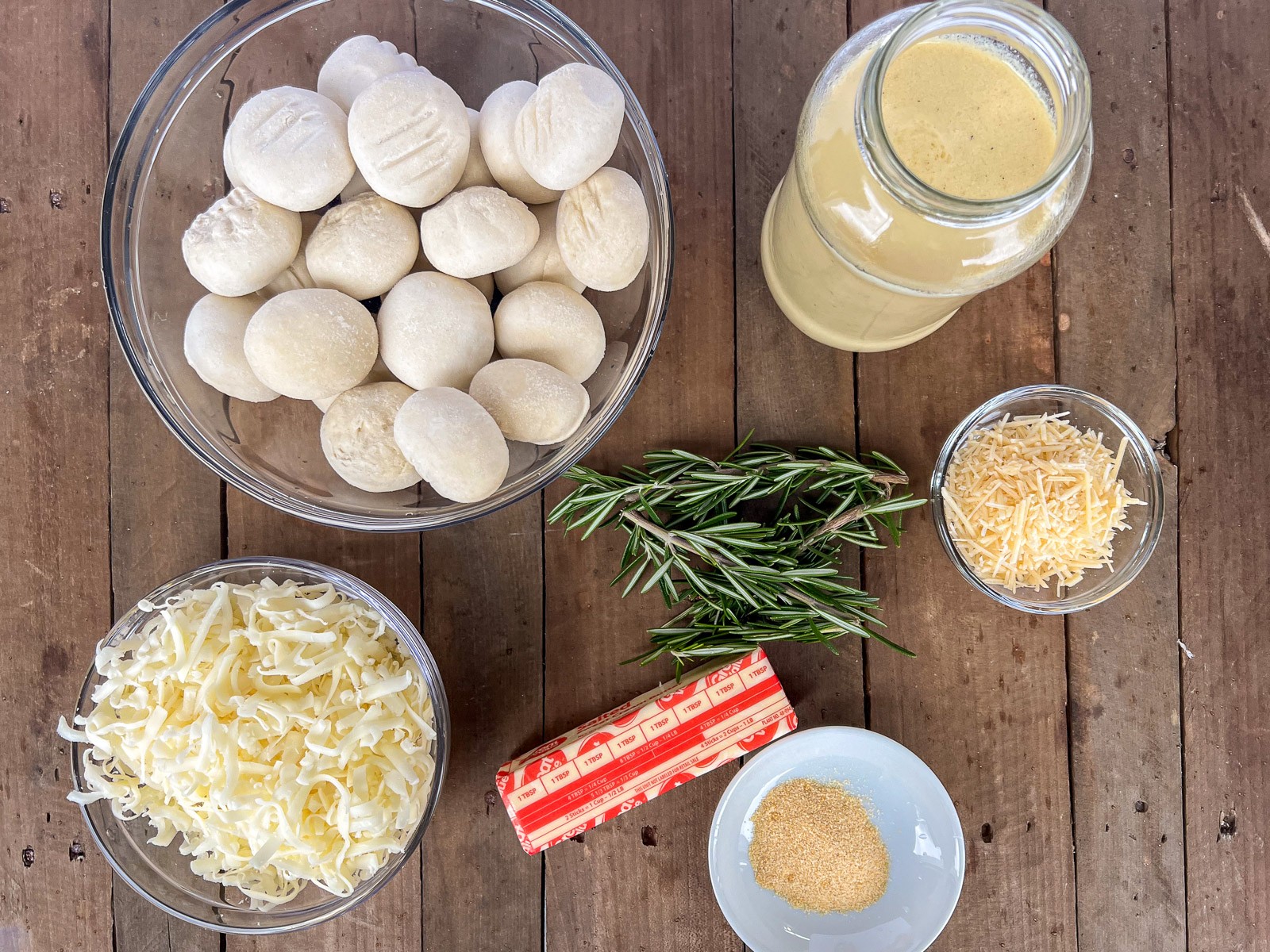 Labeled ingredient image: frozen rolls, mozzarella cheese, parmesan cheese, Alfredo sauce, rosemary, butter, and granulated garlic.