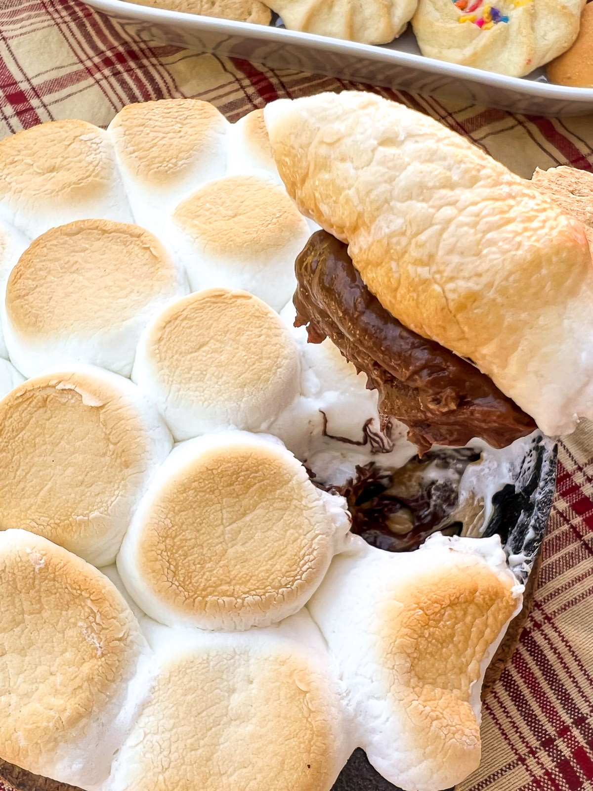 A cast iron skillet with chocolate peanut butter dip and toasted Peeps.