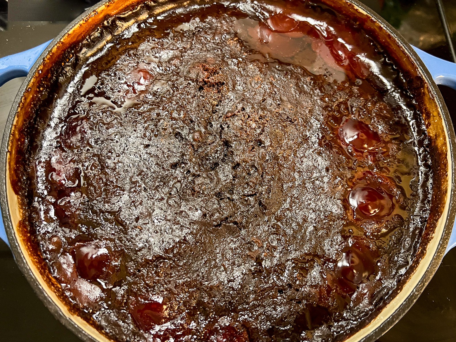 Fresh from the oven, the Cola Chocolate Cherry dump cake has bubbling fruit on the surface and a softly crusted cake topping.