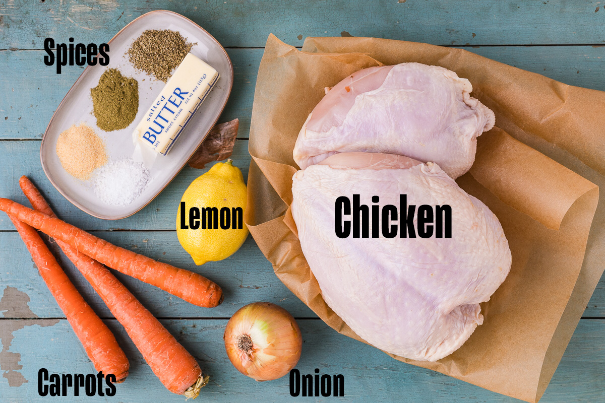 Ingredients for dutch oven chicken recipe including bone-in chicken breasts butter sage thyme lemon carrots and onion