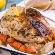 Dutch oven chicken recipe ready to be served on a white plate.
