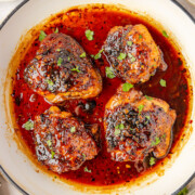Honey garlic chicken thighs in a Dutch oven.