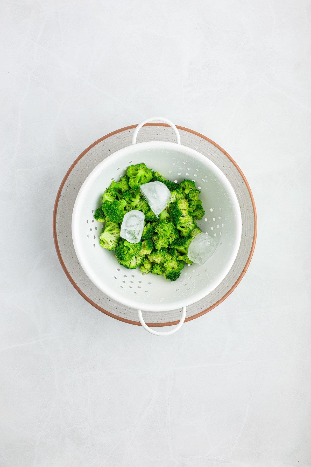 Broccoli in a strainer after blanching.