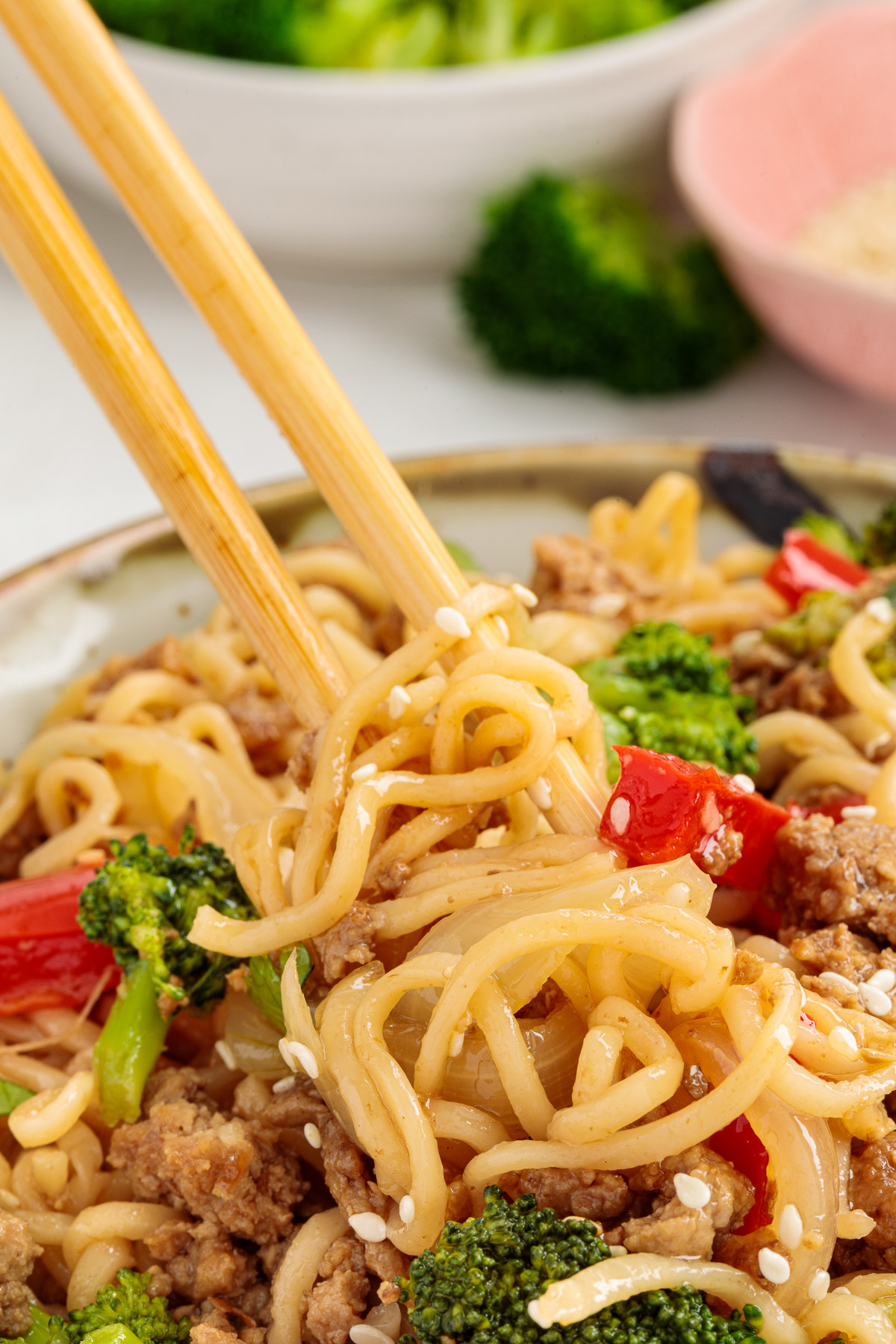 Ground turkey stir fry with chopsticks scooping up a bite. 