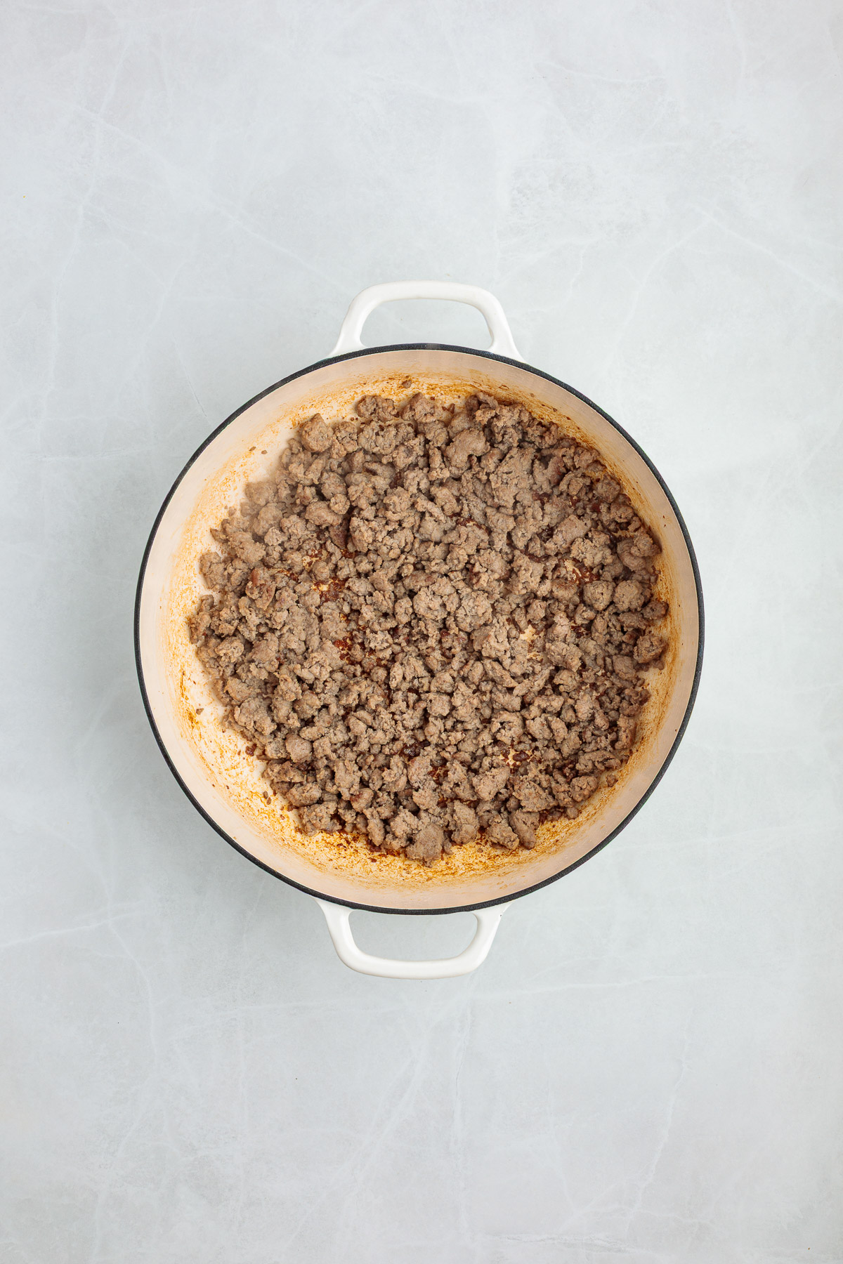 Ground turkey in a large Dutch oven.